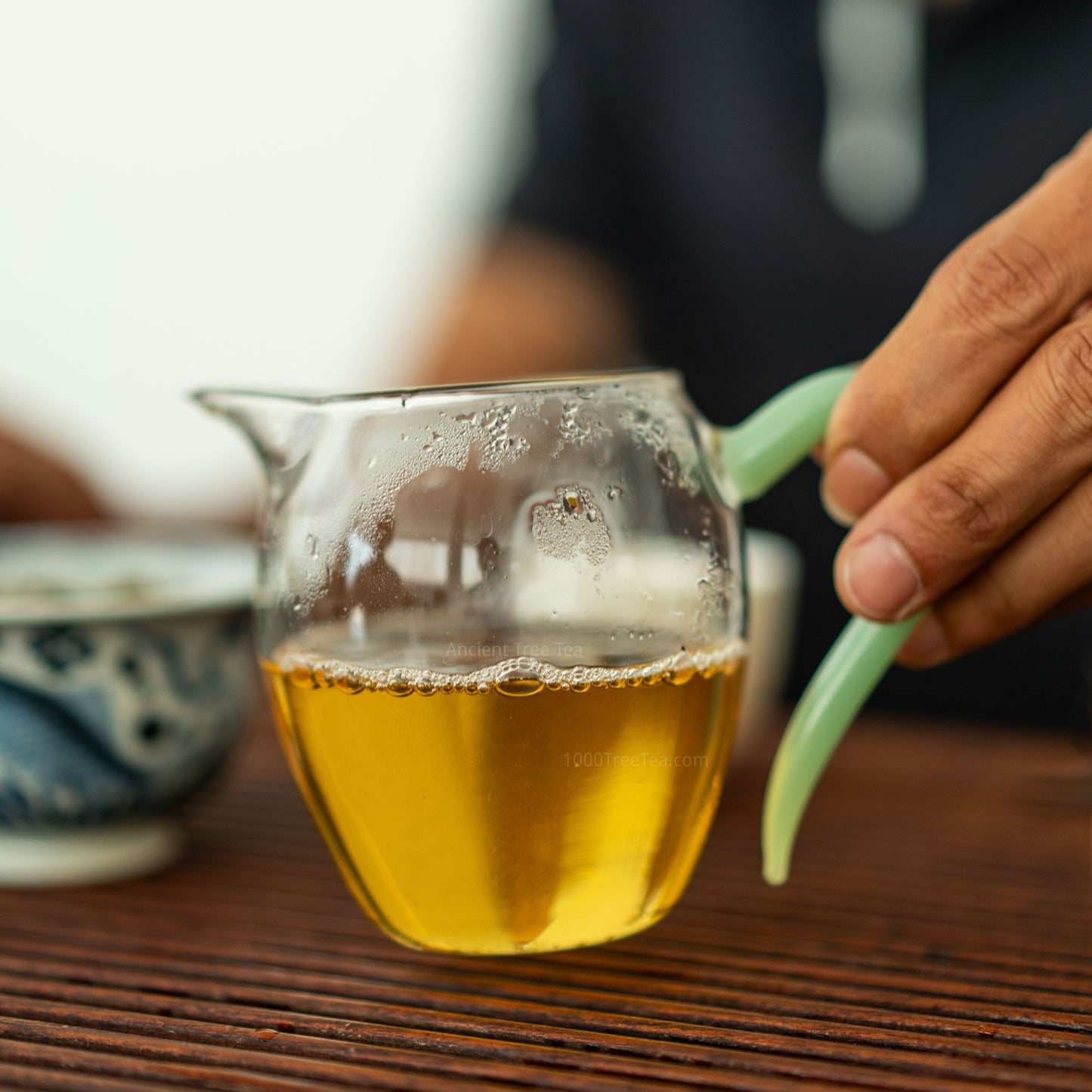 Golden liquor of Bingdao ancient tea in a pitcher