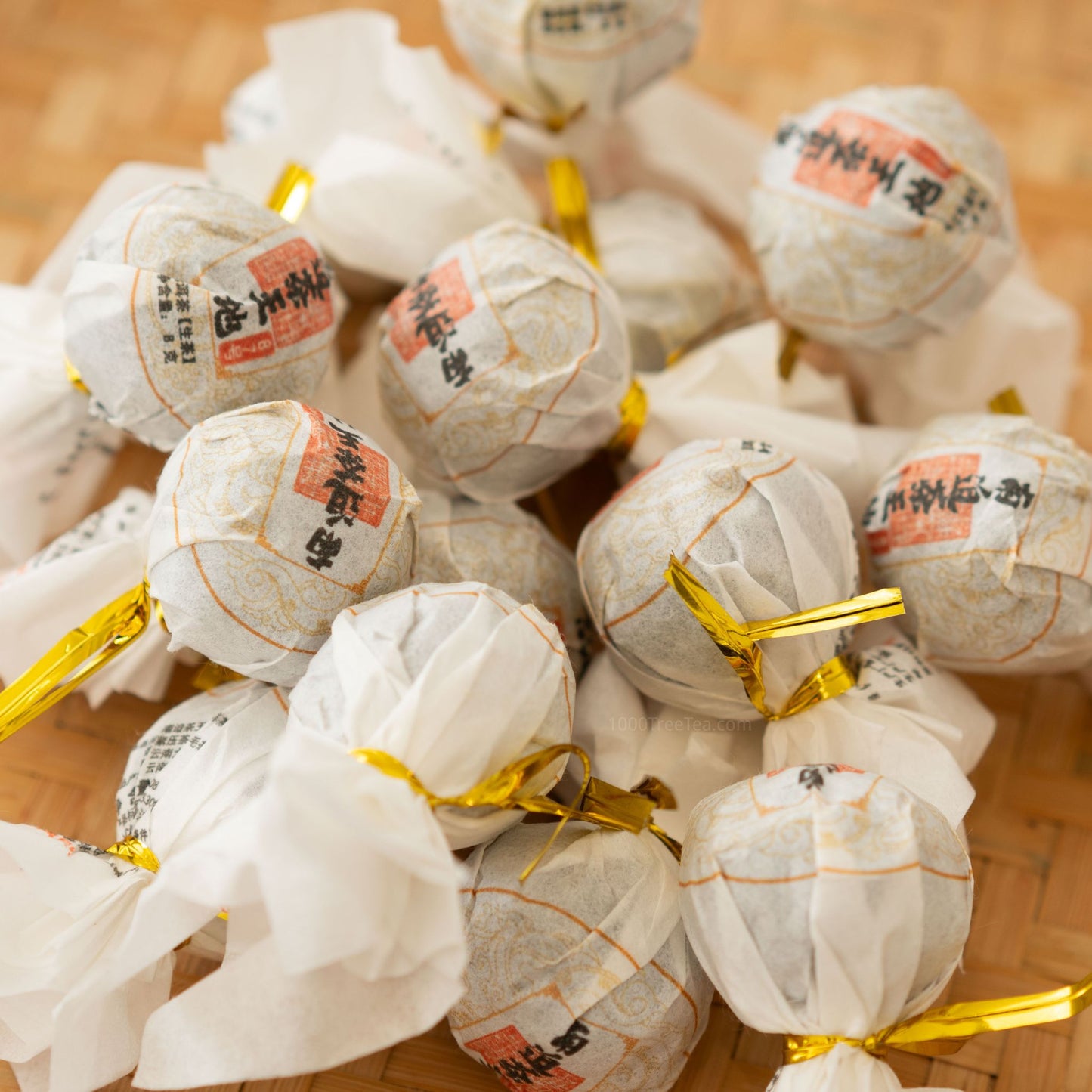 Close-up of Nanpo Dragon Ball teas wrapped in white and gold paper