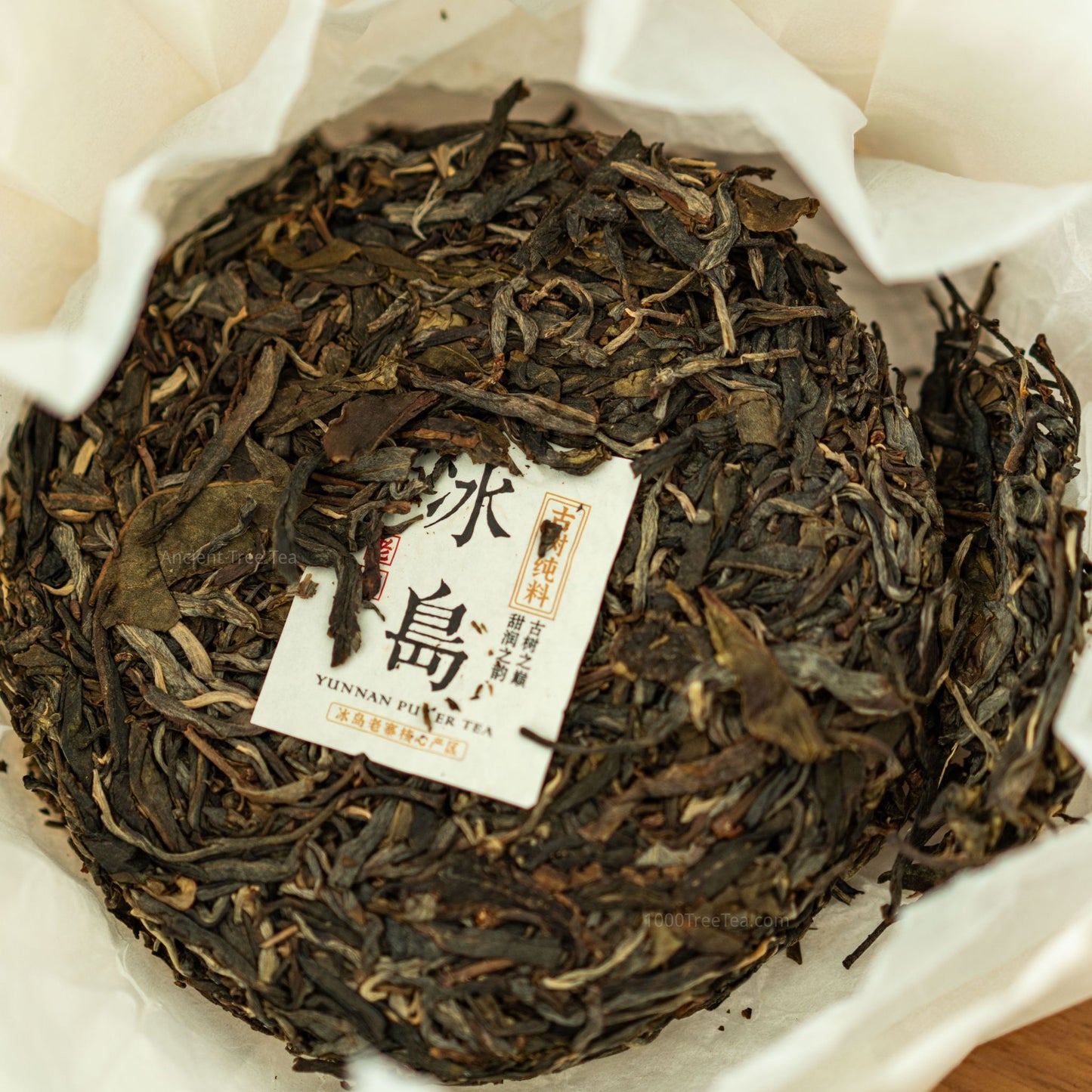 Unwrapped Bingdao Lao Zhai ancient tree tea cake, top view