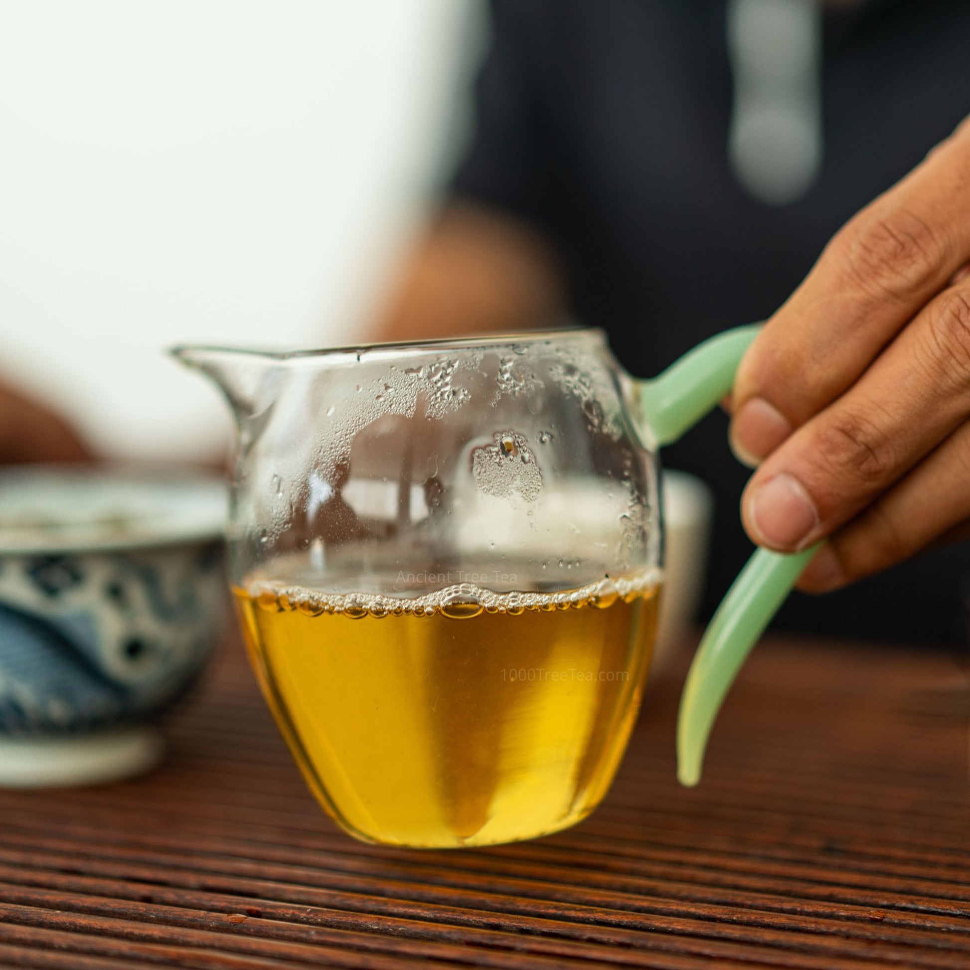 Golden liquor of Bingdao ancient tea in a pitcher